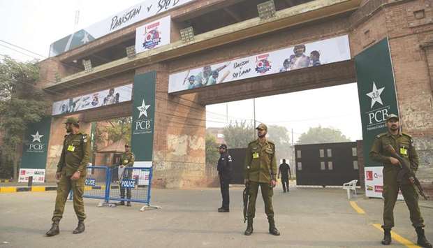 Pakistani policemen stand guard at an entrance of the Gaddafi Cricket Stadium ahead of the last T20 cricket match between Pakistan and Sri Lanka, in Lahore, Pakistan, yesterday. (AFP)