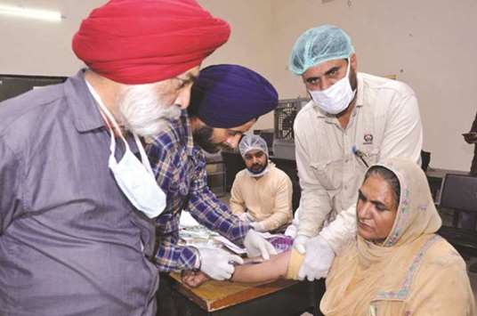 Doctors collect blood samples of family members of Punjabi men who went missing in Iraq, in Amritsar yesterday.