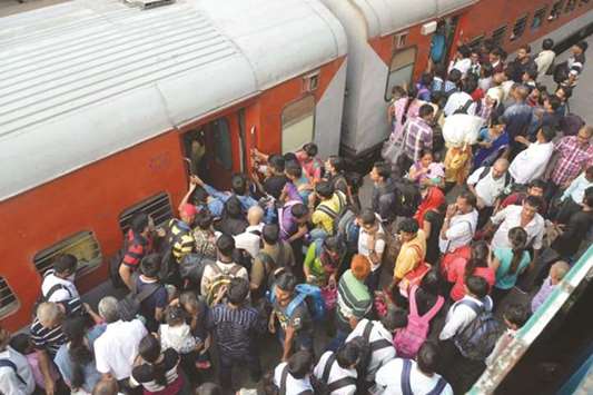 Passengers try to board a train at Patna Junction railway station yesterday.