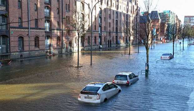 Flood waters surround cars parked at Hamburg's Fish Market district  as a storm hit many parts of Germany