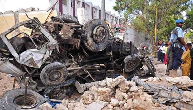 A burnt car is seen at the scene of a blast in Mogadishu on Sunday.