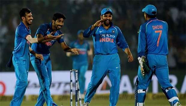 Indian cricketers celebrate the dismissal of New Zealand's Tom Latham during the third one-day international at the Green Park Cricket Stadium in Kanpur on Sunday.