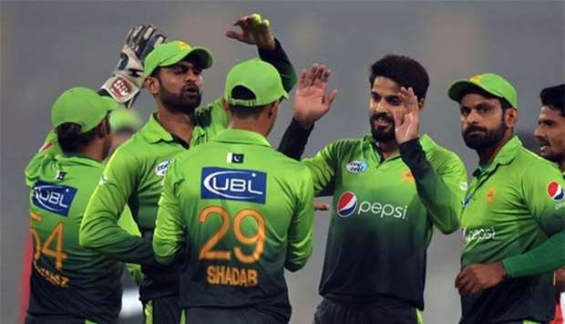 Pakistani cricketers celebrate the dismissal of Sri Lankan captain Thisara Perera during the third and final T20 match at the Gaddafi stadium in Lahore on Sunday.
