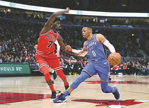 Oklahoma City Thunder guard Russell Westbrook (R) dribbles the ball against Chicago Bulls guard Justin Holiday during their NBA game at the United Centre on Saturday. PICTURE: USA TODAY Sports