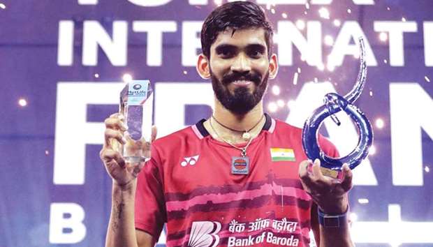 Indiau2019s Kidambi Srikanth poses with his trophies on the podium after winning the French Open Superseries badminton tournament in Paris yesterday. (AFP)