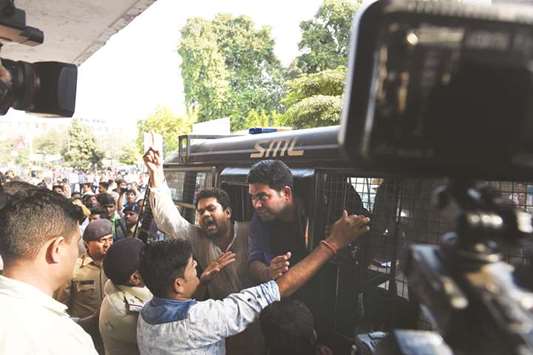 Congress Party supporters shout anti-government slogans inside a police vehicle after they were removed by police while protesting outside the Government Civil Hospital medical superintendentu2019s office in Ahmedabad yesterday.
