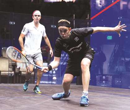 Englandu2019s James Willstrop (foreground) plays a shot during their first round Qatar Classic match against Peruu2019s Diego Elias at Khalifa International Tennis and Squash Complex in Doha yesterday. PICTURE: Jayan Orma