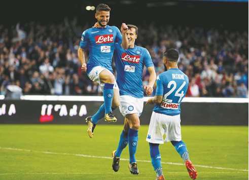 Napoliu2019s Dries Mertens (left) celebrates with teammates after scoring against Sassuolo during the Serie A match yesterday. (Reuters)