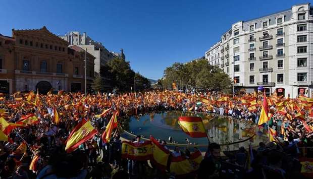 Protesters wave Spanish and Catalan Senyera flags during a pro-unity demonstration in Barcelona