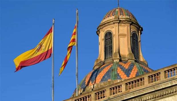 Spanish and Catalan flags are pictured on top of the 'Generalitat' palace (Catalan government headquarters) in Barcelona on Monday.