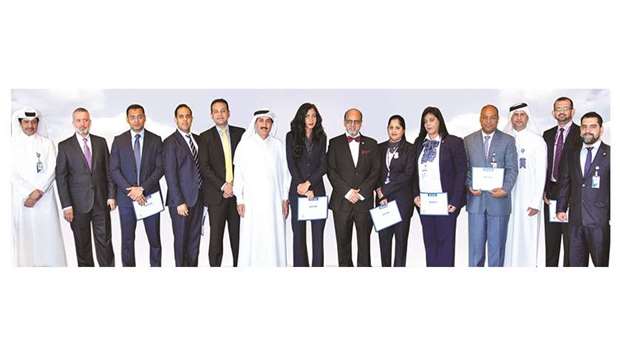 Doha Bank executives with the recipients of the monthly u2018Employee Recognition Awardsu2019 for August 2017.