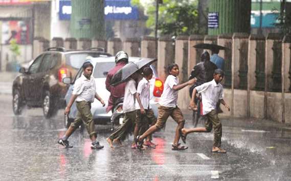 School students run along a street during rains in Chennai yesterday. Heavy rains lashed several parts of Tamil Nadu, including Chennai, leading to water-logging and traffic snarls. Several schools in Chennai closed early because of the rains. All schools and colleges in Chennai and Kancheepuram will remain closed today, officials said. The northeast monsoon brings most of the rainfall to Tamil Nadu.