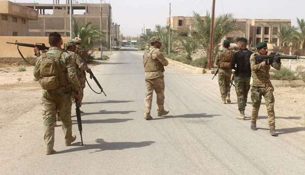 Iraqi forces members patrol during a military operation in the northwestern Anbar province