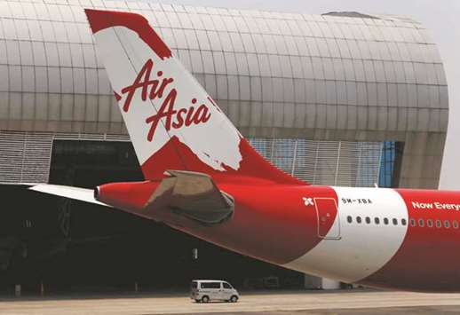 Tail of AirAsia X plane is seen at the Garuda Maintenance Facility AeroAsia in Tangerang, Indonesia. AirAsia  said yesterday it plans to sell more stakes in non-flying businesses to fund special dividends to shareholders, after announcing a new ground handling joint venture with Singaporeu2019s SATS.