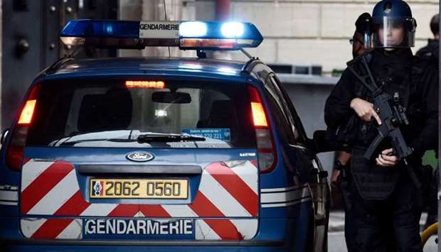 Armed French policemen stand guard