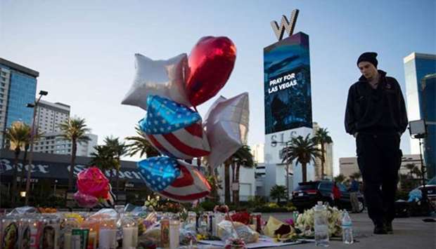 Matthew Helms, who worked as a medic on the night of the shooting, visits a makeshift memorial for the victims in Las Vegas on Tuesday.