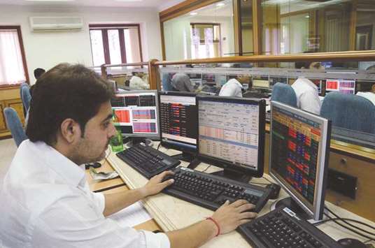A stock broker looks at the Bombay Stock Exchange trading terminal in Mumbai. The Sensex closed up 213.66 points to 31,497.38 yesterday.