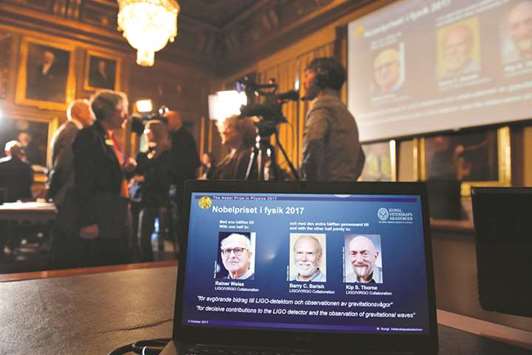The names of Rainer Weiss, Barry C Barish, and Kip S Thorne are displayed on the screen during the announcement of the winners of the Nobel Prize in physics 2017, in Stockholm.