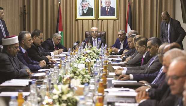 Palestinian Prime Minister Rami Hamdallah (centre) chairs a cabinet meeting in Gaza City yesterday.