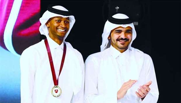 Qatar Olympic Committee president HE Sheikh Joaan bin Hamad al-Thani (right) with Qatari high jumper and world champion Mutaz Barshim at the Sports Excellency Awards 2016-17 at Qatar National Convention Center on Wednesday.
