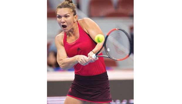 Simona Halep of Romania hits a return during her match against Maria Sharapova of Russia at the China Open in Beijing yesterday. (AFP)