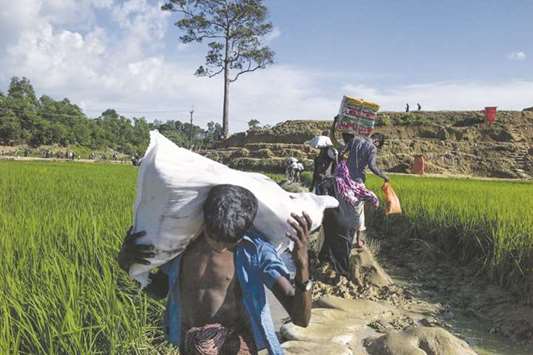Rohingya refugees reach Balukhali camp by the field in Bangladeshu2019s Ukhiya district yesterday.