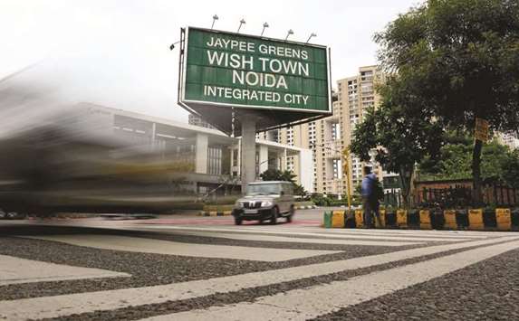 Vehicles passby an entry gate of Jaypeeu2019s Wish Town in Noida, a suburb of New Delhi. Hundreds of homebuyers yesterday petitioned the Supreme Court to challenge the countryu2019s insolvency law.
