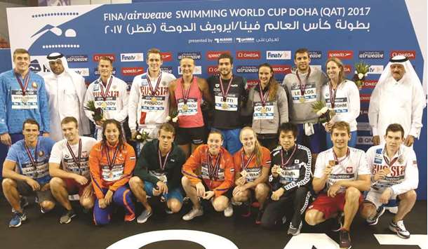 Swimmers pose with their medals after day one of the FINA Swimming World Cup at the Hamad Aquatic Centre in Doha yesterday. PICTURE: Noushad Thekkayil