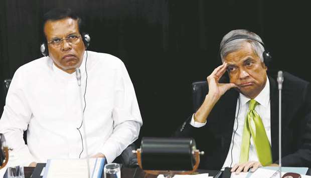 Sri Lankau2019s President Maithripala Sirisena and Prime Minister Ranil Wickremesinghe look on during a parliament session marking the 70th anniversary of Sri Lanka government, in Colombo, yesterday.