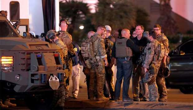 FBI agents confer in front of the Tropicana hotel-casino after  mass shooting