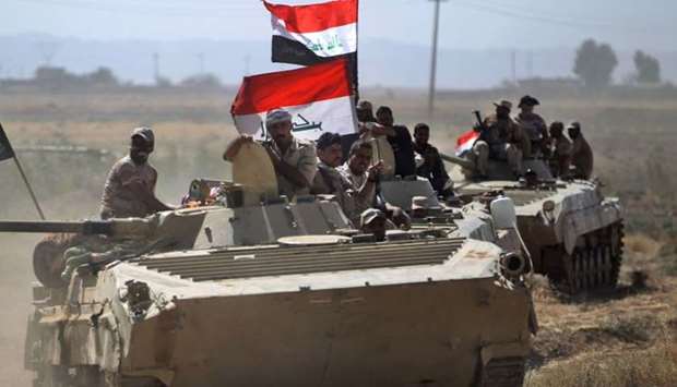 Iraqi forces advance during an operation to recapture the town