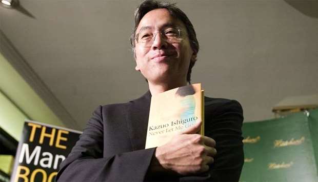 Kazuo Ishiguro posing with his book