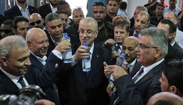 Palestinian Prime Minister Rami Hamdallah visits a water desalination plant in Deir el-Balah in central Gaza on Thursday.