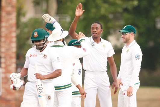 In this September 29, 2017, picture, South Africau2019s Kagiso Rabada (second from right) celebrates the dismissal of Bangladesh batsman Imrul Kayes (left) on the second day of the first Test in Potchefstroom, South Africa. (AFP)