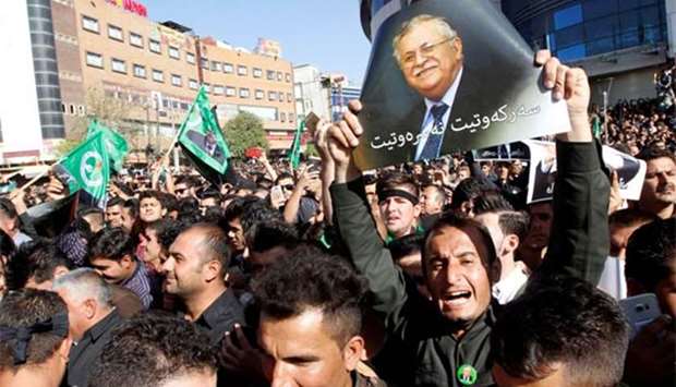A Kurdish mourner holds a picture of former Iraqi president Jalal Talabani in Sulaimaniya on Friday.