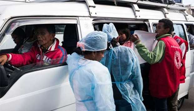 Doctors and nurses talk to people as they intensify efforts to halt a plague outbreak, in Antananarivo.