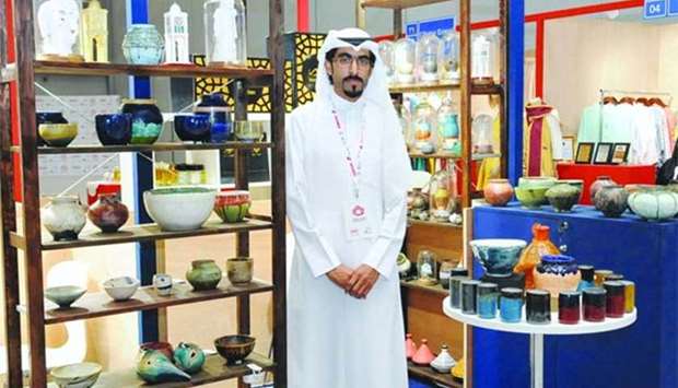 Qatari pottery artist Talal Nayef al-Qasimi stands beside his creations during the 'Made at Home' expo held recently. PICTURES: Nasar T K.