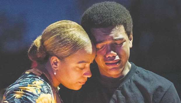 Veronica Hartfield, the widow of slain Las Vegas officer Charleston Hartfield, and their son Ayzayah, 15, are seen at the vigil for Hartfield.