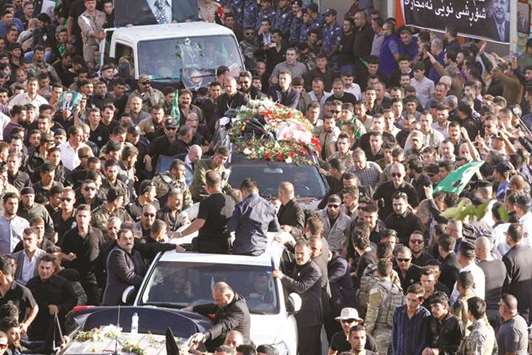Kurdish mourners surround the car carrying the coffin of former Iraqi president Jalal Talabani in Sulaimaniyah, Iraq yesterday.