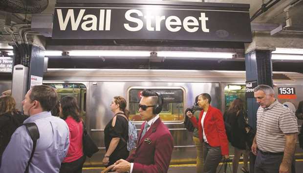 Commuters exit the Wall Street subway station near the New York Stock Exchange yesterday. Total non-farm employment fell by 33,000 net positions for September, with a steep drop-off in hiring at restaurants, according to the Labour Department.