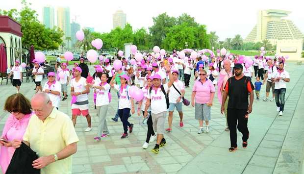 People participate in a QCS event to raise awareness of breast cancer
