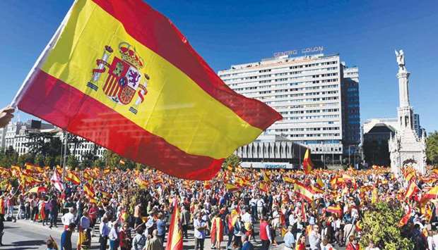 Protesters gather holding Spanish flags during a demonstration against Cataloniau2019s independence at Madridu2019s Colon Square.
