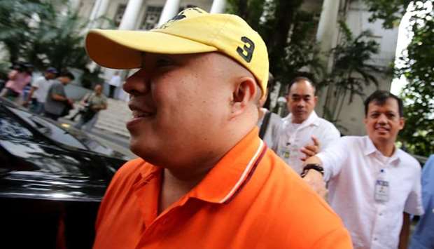 Russel Salic smiling after a hearing at the Department of Justice (DOJ) in Manila