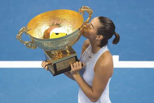 Caroline Garcia of France kisses the trophy after winning the final against Simona Halep of Romania at the China Open in Beijing. (AFP)