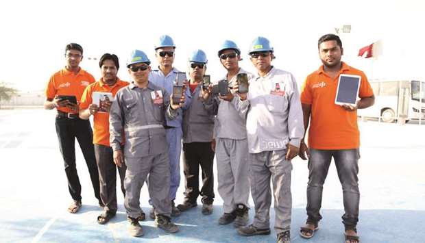 SC project workers with their cellphones after downloading the Commercial Bank app.