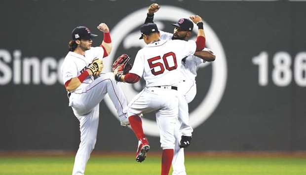 Boston Red Sox left fielder Andrew Benintendi (left), right fielder Mookie Betts and centre fielder Jackie Bradley Jr. (right) celebrate after beating the Houston Astros in game three of the 2017 ALDS at Fenway Park. PICTURE: USA TODAY Sports