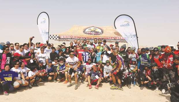 Riders and officials pose after the Al Kheesa XCO Race of the Qatar Mountain Bike League (QMBL) season.