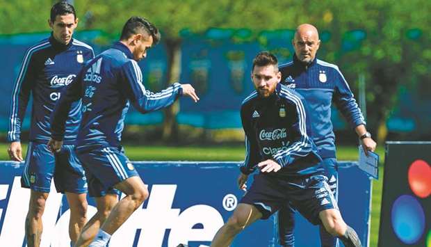 Argentinau2019s forwards Lautaro Acosta (2nd-L),  Lionel Messi (2nd-R) and midfielder Angel Di Maria (back) take part in a training session in Ezeiza, Buenos Aires.