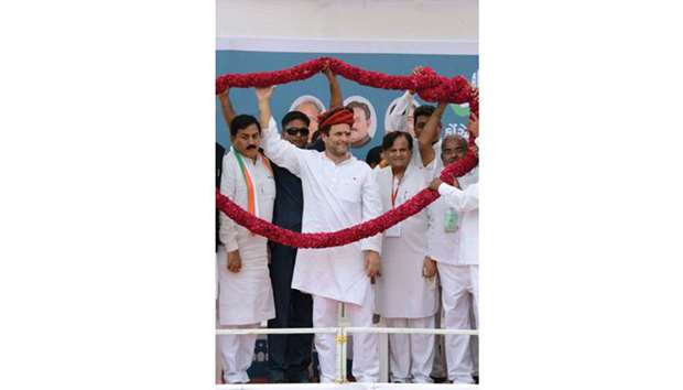 Congress vice president Rahul Gandhi (C), senior party leader Ahmed Patel (right) and Gujarat Congress president Bharatsinh Solanki (left) stand under a common garland upon arriving at Khatraj village, some 35km from Ahmedabad yesterday.