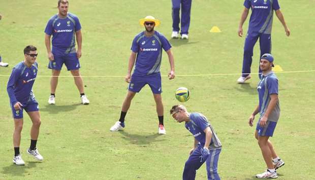 Australiau2019s captain David Warner (right) plays football with teammates during a training session in Guwahati, India. (AFP)